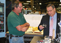 Employee David Gay and Governor LePage in the shop